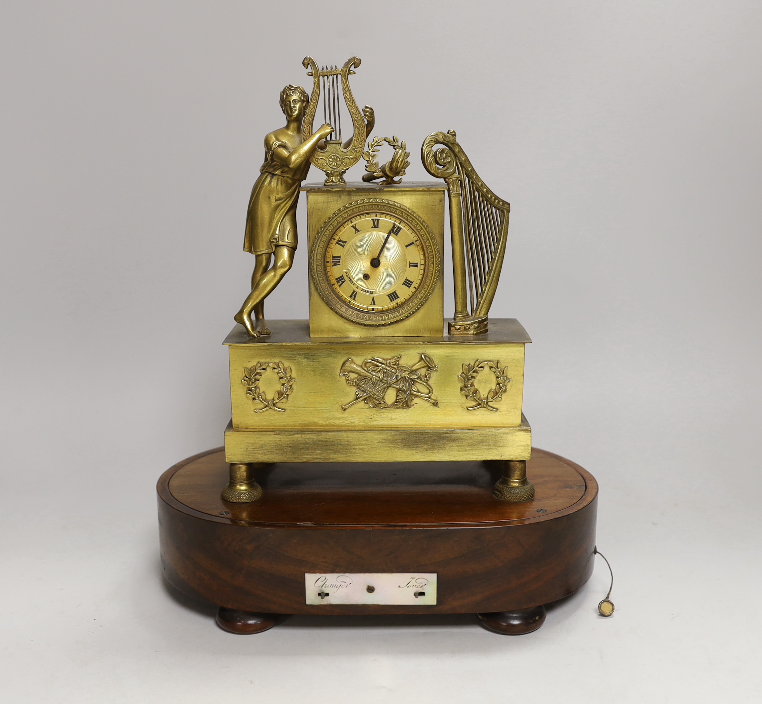A 19th century French musical mantel timepiece, the dial inscribed Albert A Paris, the mahogany base with music box movement, 29cm high